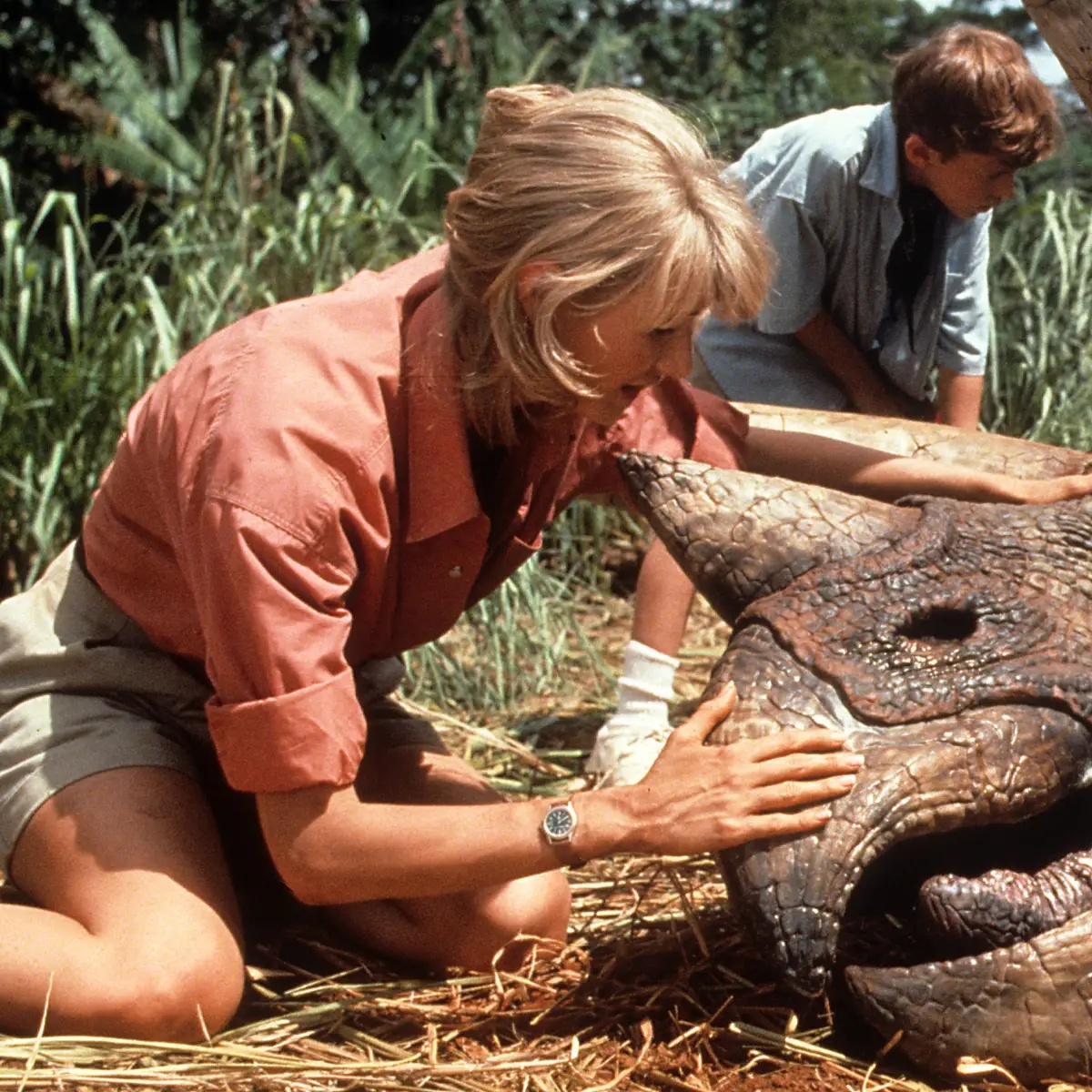 Laura Dern as Ellie Sattler wearing a military-dial Timex beside a sick Triceratops in Jurassic Park