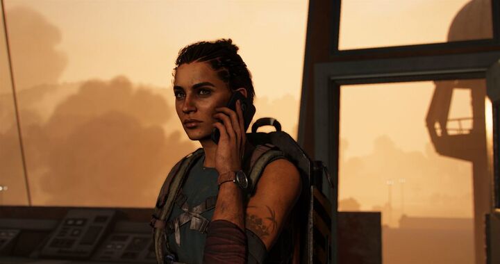 Dani holds a telephone with a round field watch on a brown strap visible at the wrist.
