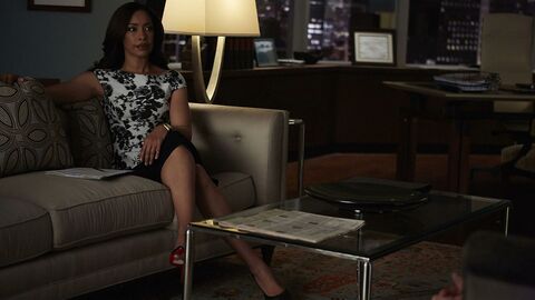 Jessica Pearson seated in her office, with a gold-toned rectangular watch case and black strap visible on her left wrist in a production photograph for Gone.