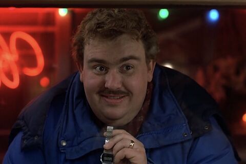 John Candy as Del Griffith with the Casio W-34 in Planes, Trains and Automobiles (1987)