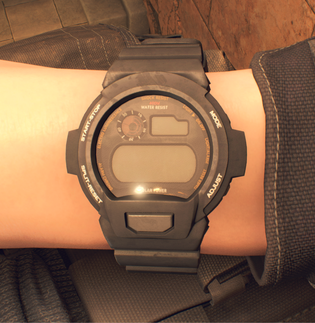 Black digital watch with a large lower display, smaller upper indicators and molded button labels.