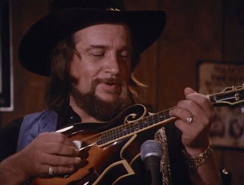 Waylon Jennings as The Balladeer (himself) with the Baume & Mercier watch in The Dukes of Hazzard (1979)