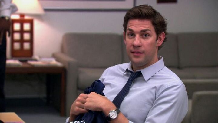 John Krasinski as Jim Halpert seated in the office with a Victorinox Swiss Army Infantry visible on his left wrist