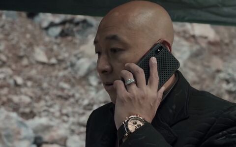 The wearer as Chen Jianbo with the Rolex Daytona 116515LN in Crime Crackdown (2021)