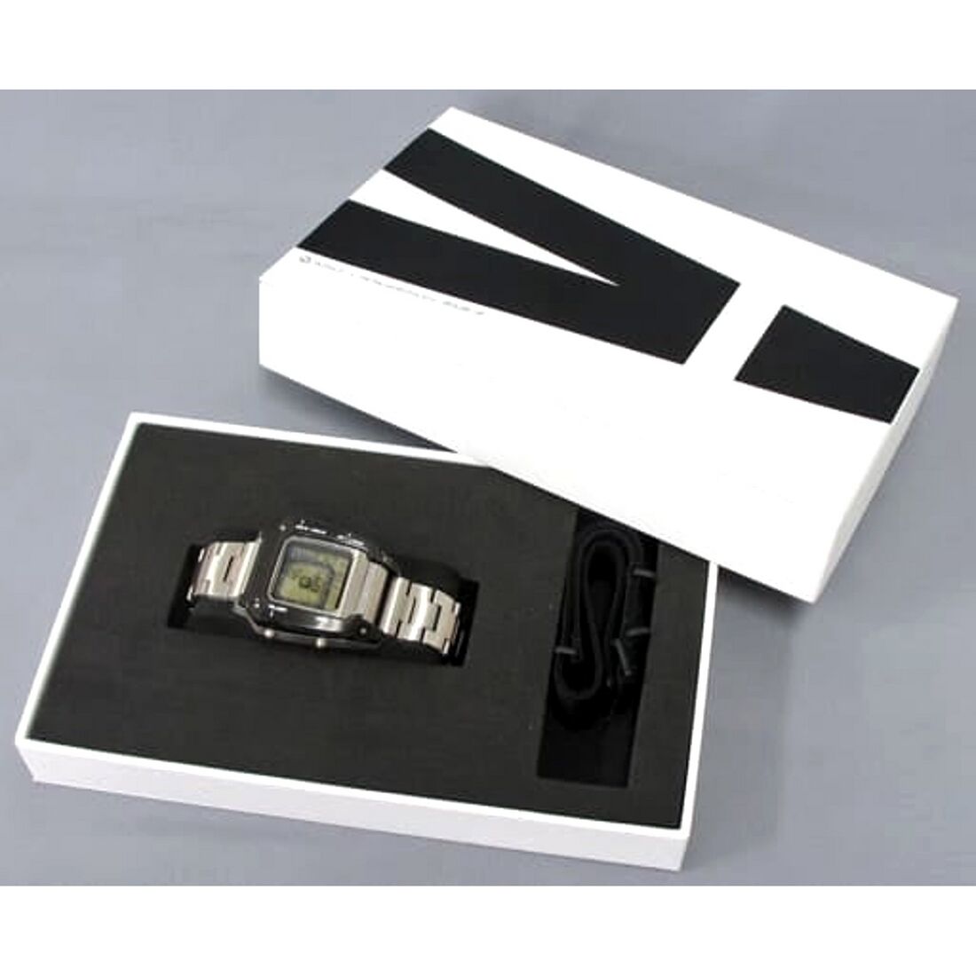 Silver digital WIRED watch in an open black-and-white presentation box.
