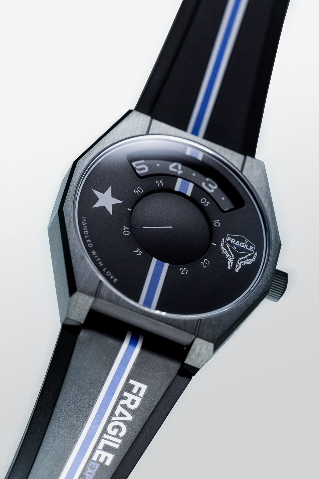 Black disc-display watch with a blue stripe and Fragile Express lettering on the strap.