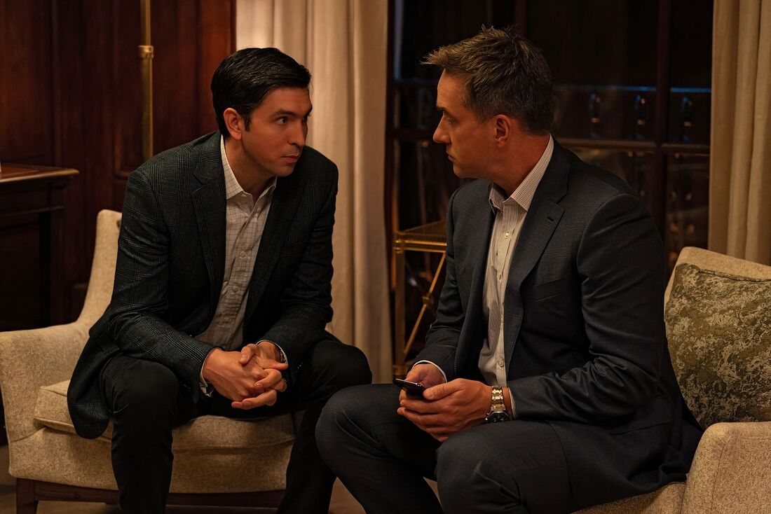 Tom holds a phone while talking to Greg, exposing the Royal Oak bracelet and dark chronograph dial.