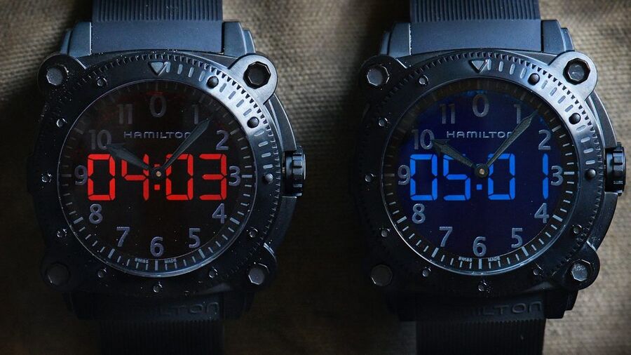 Two modified Hamilton Khaki BeLOWZERO props from Tenet with red and blue digital displays