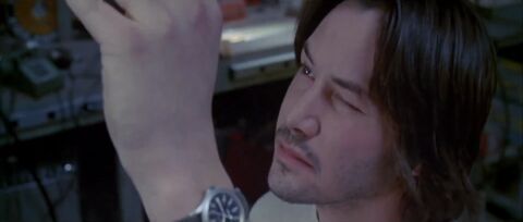 Keanu Reeves as Eddie Kasalivich with the Hamilton Khaki King in Chain Reaction (1996)