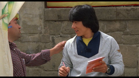 Jackie Chan as Thomas with the Citizen (unidentified model) in Wheels on Meals (1984)